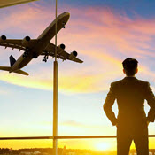 Silhouette of man and plane flying overhead