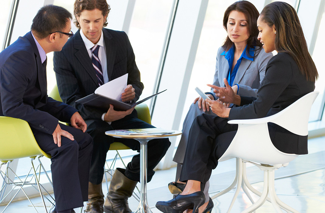 Businesspeople consulting in FBO terminal waiting area