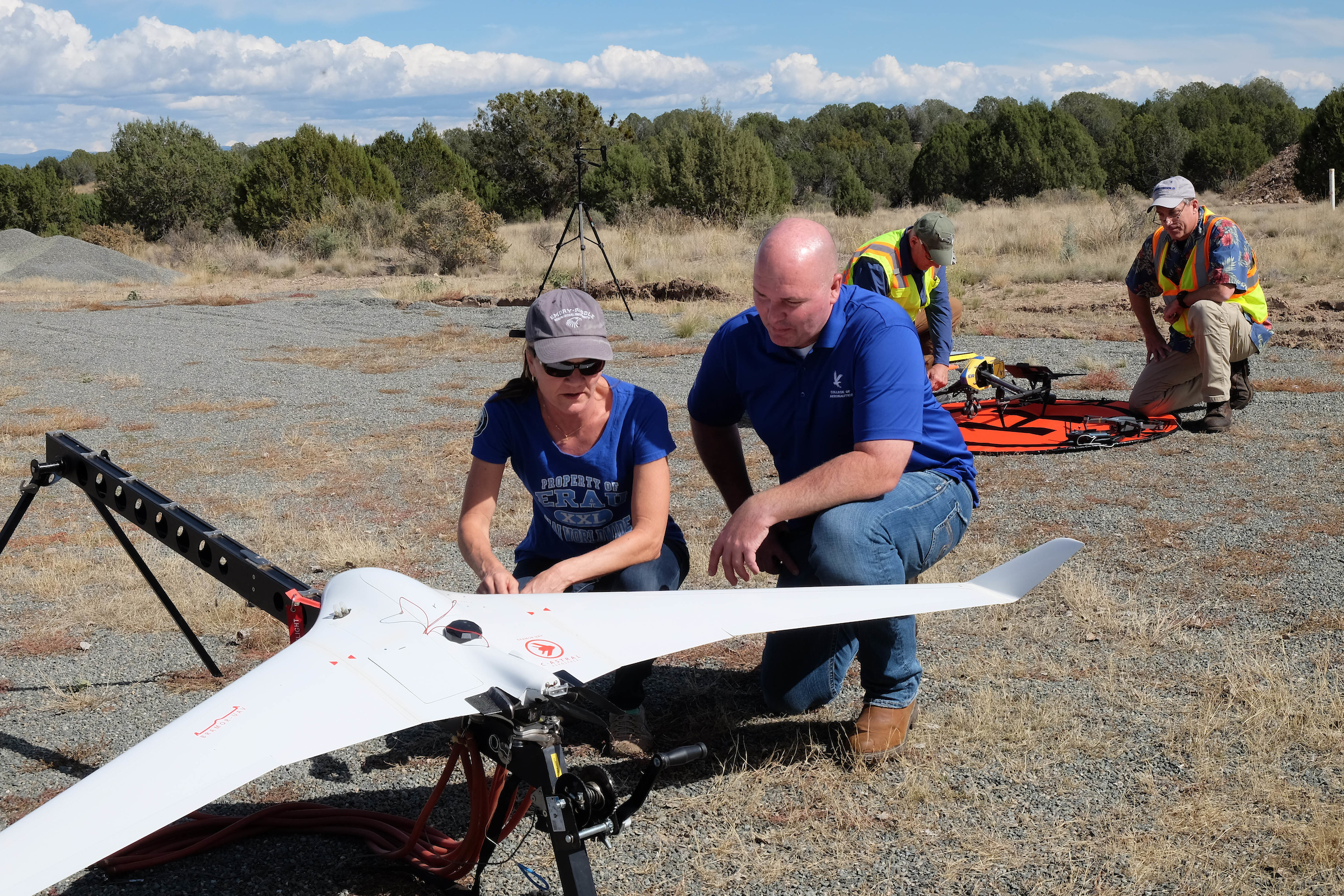 Two people prepping sUAS for flight