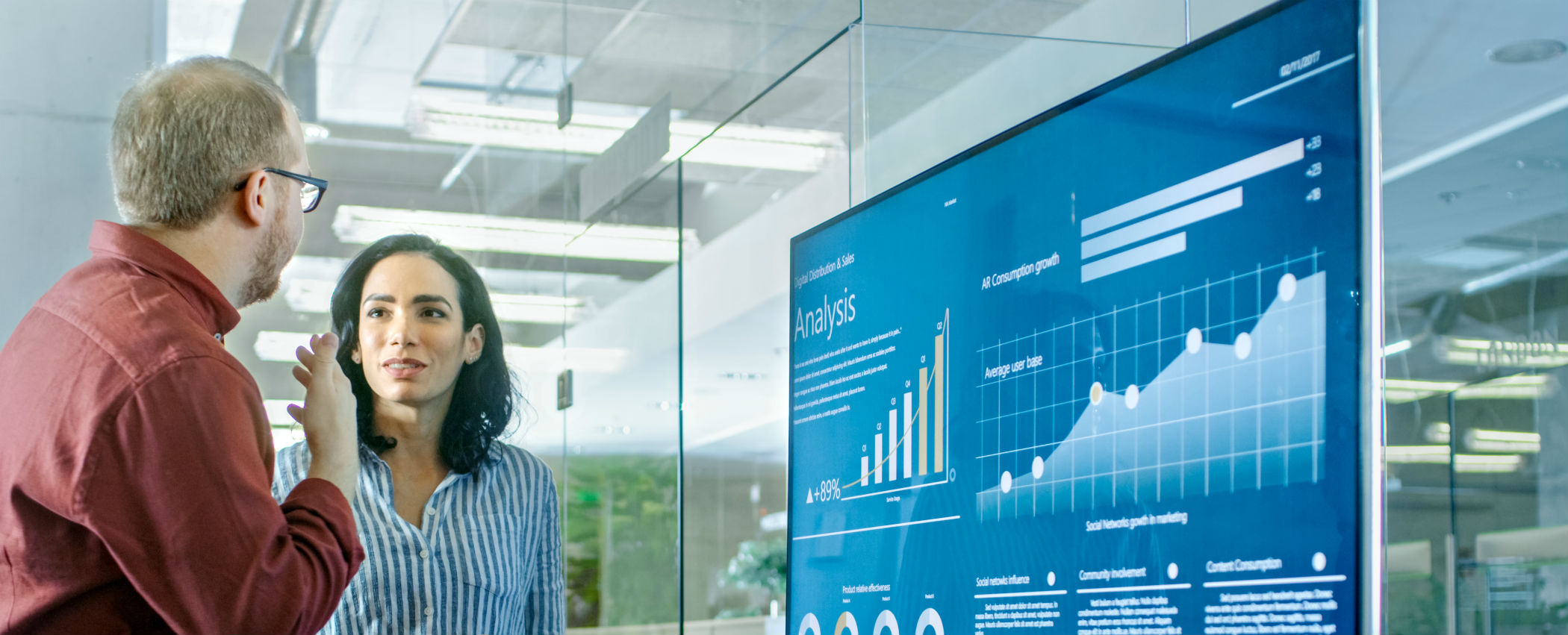 Two people reviewing graphics in a modern meeting room