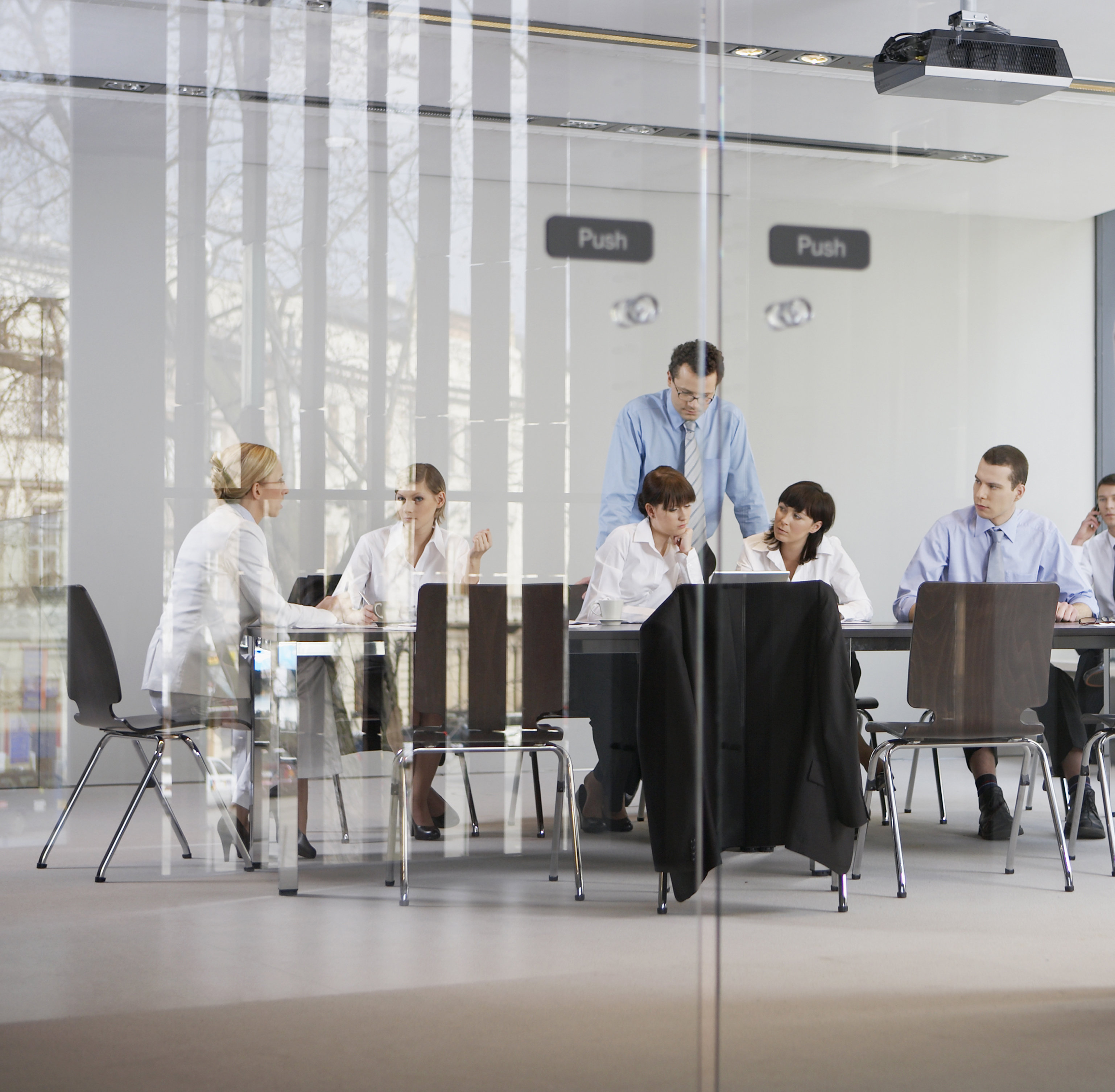 Businesspeople gathered in a shared meeting space