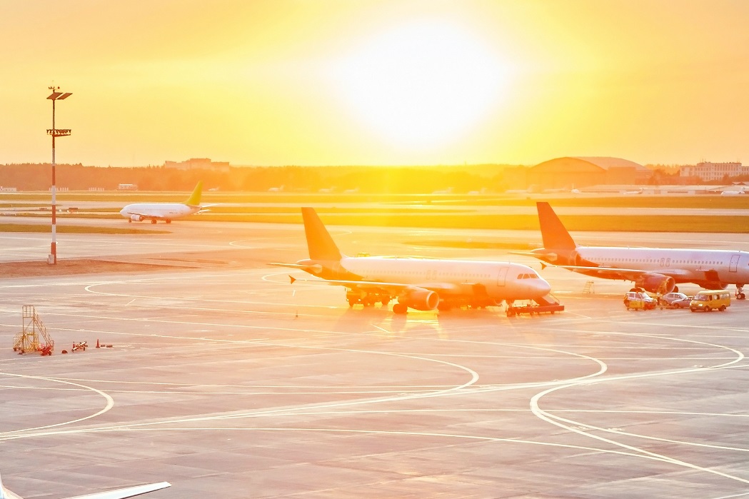 Airplanes on runway at sunset