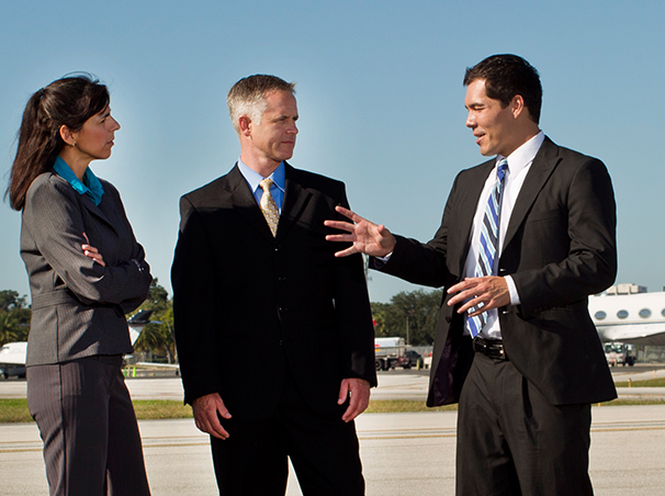 Three businesspeople consulting on a runway