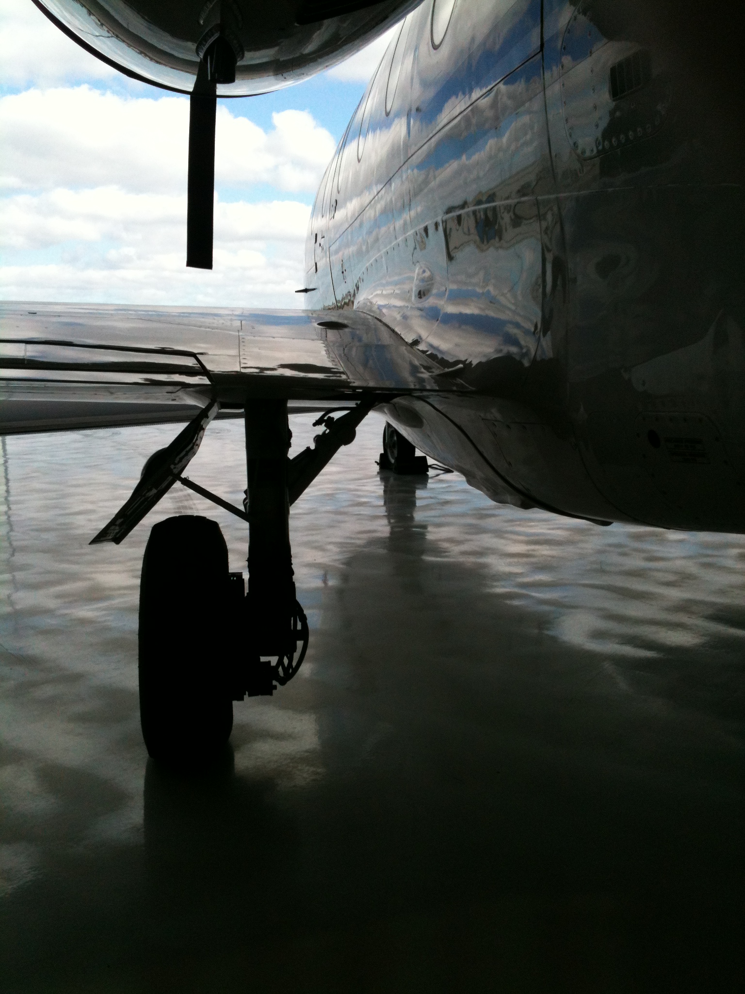 Looking down the side of a small jet on the runway