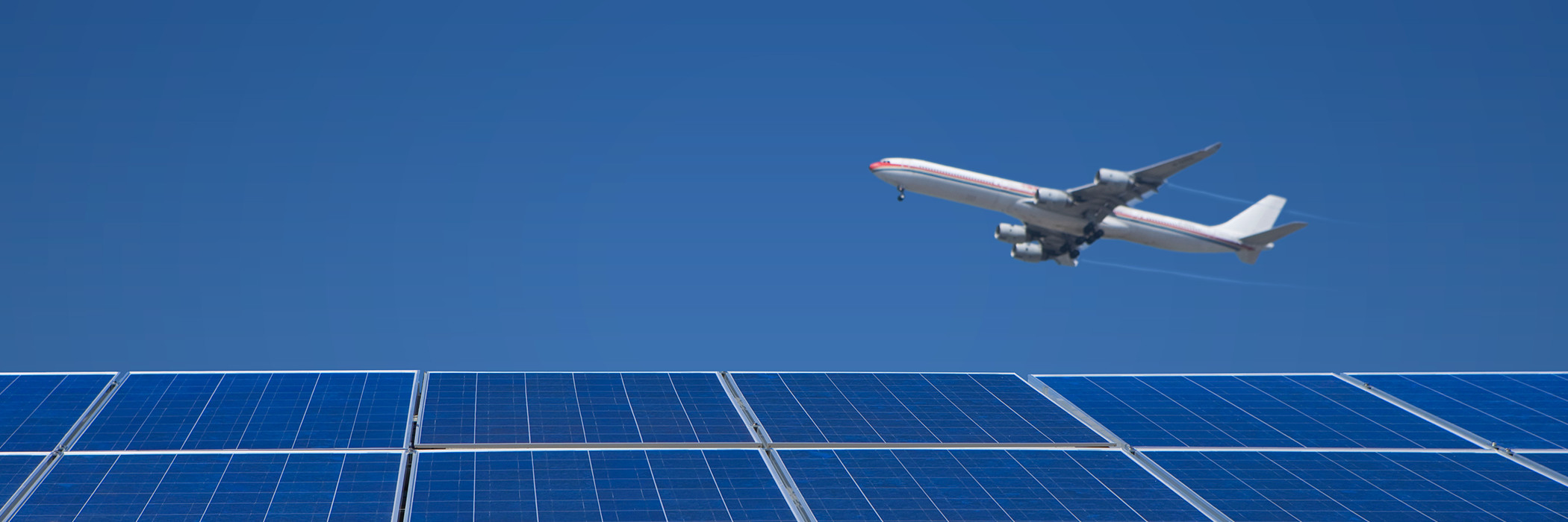 Jet flying over solar panels