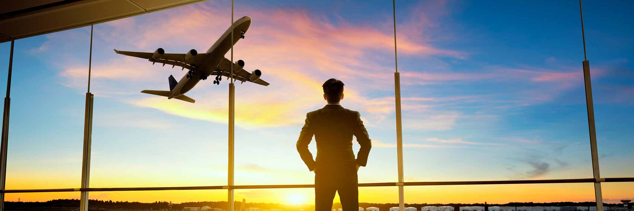 Silhouette of man and plane flying overhead