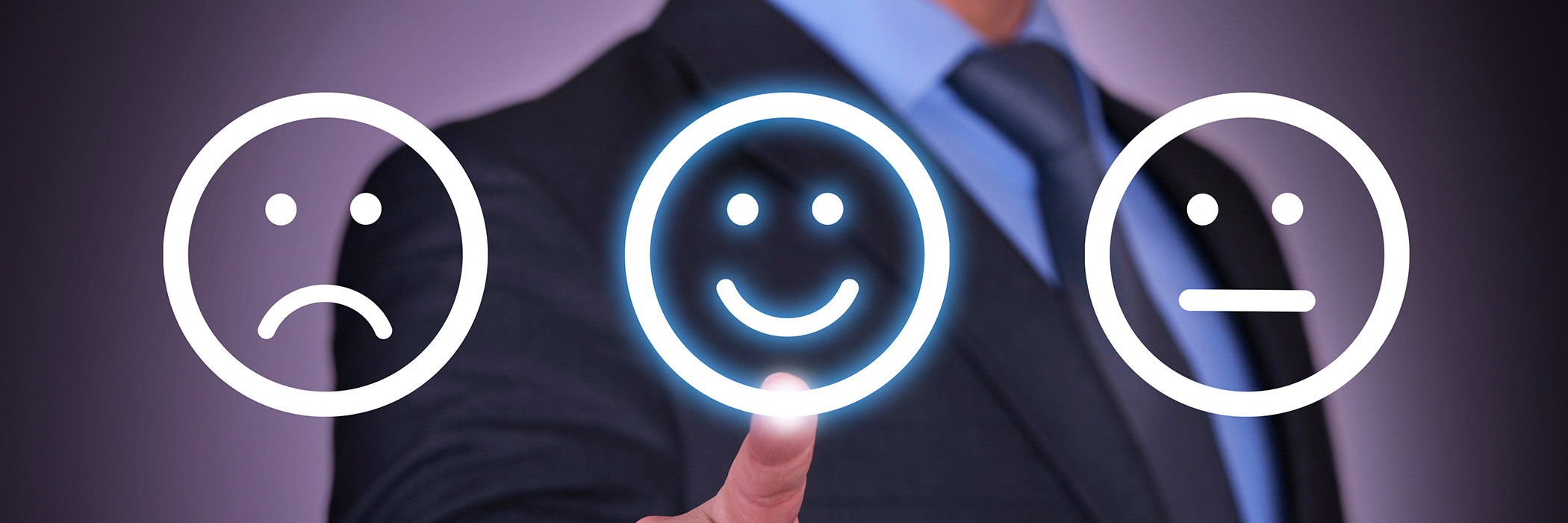 Man choosing between sad, happy, and neutral face icons