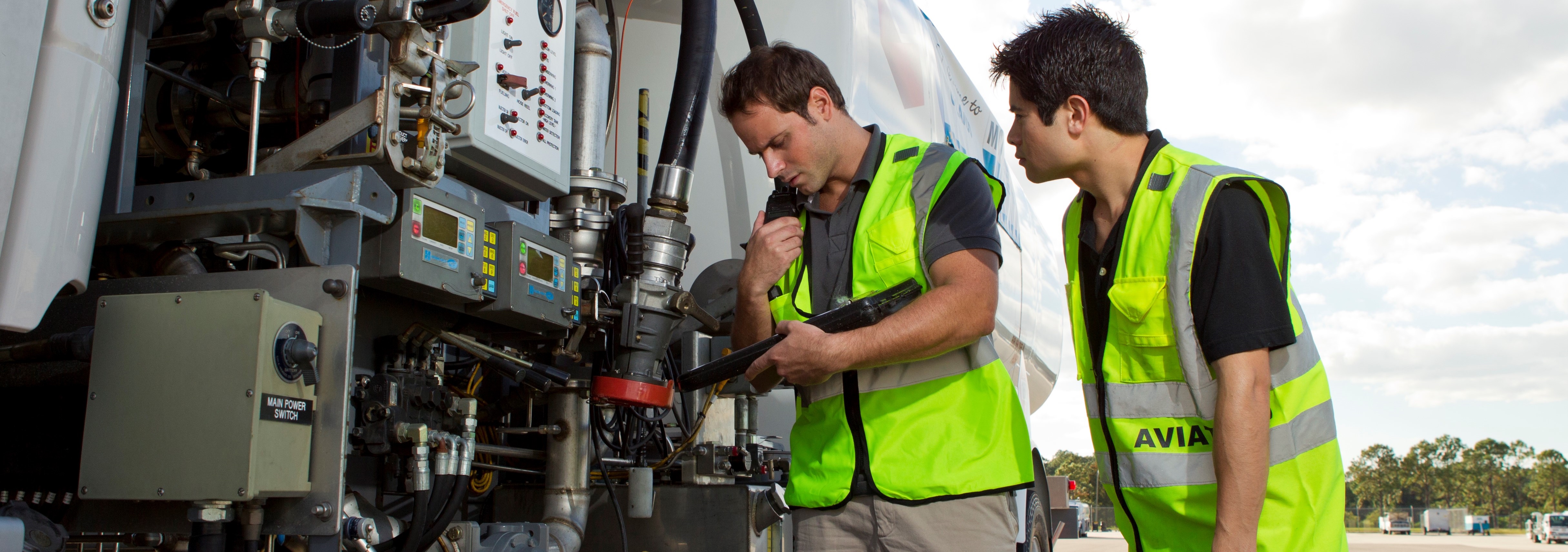 Two employees operating plane refueling truck