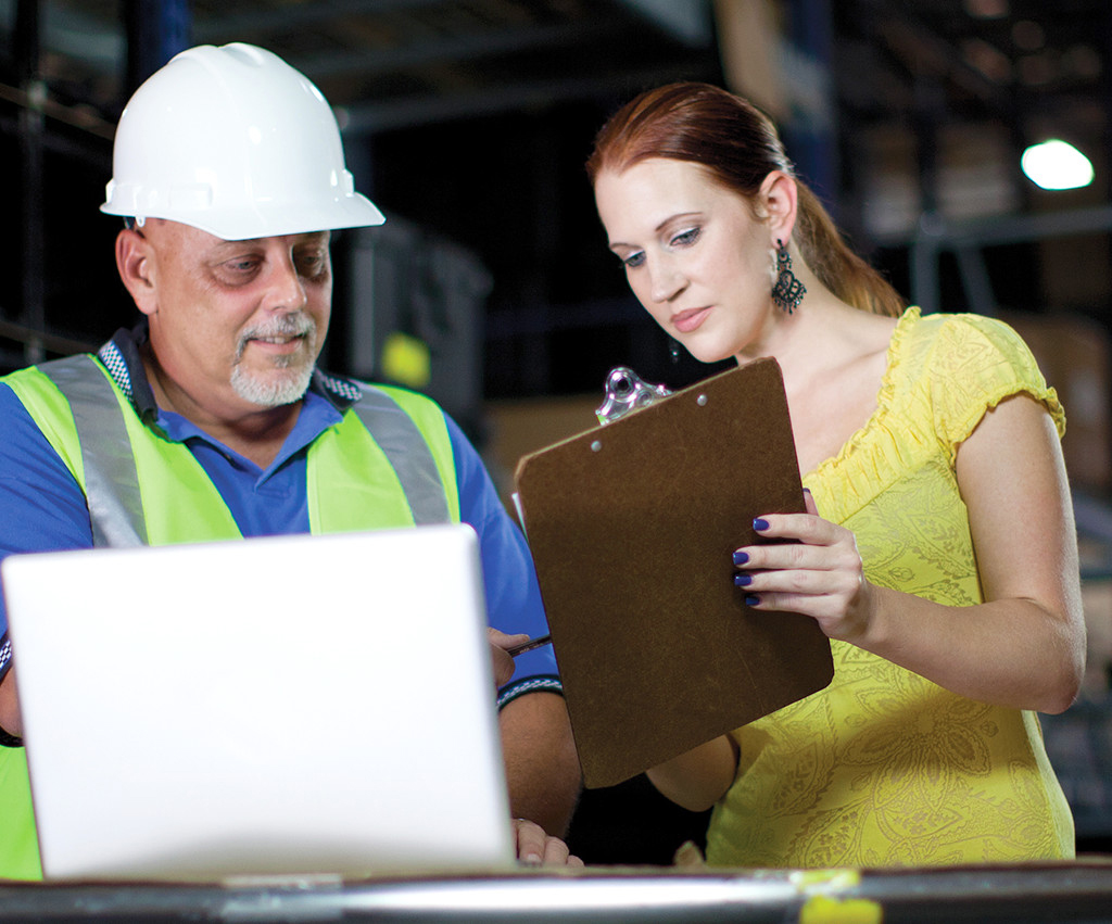 Woman consulting with warehouse manager