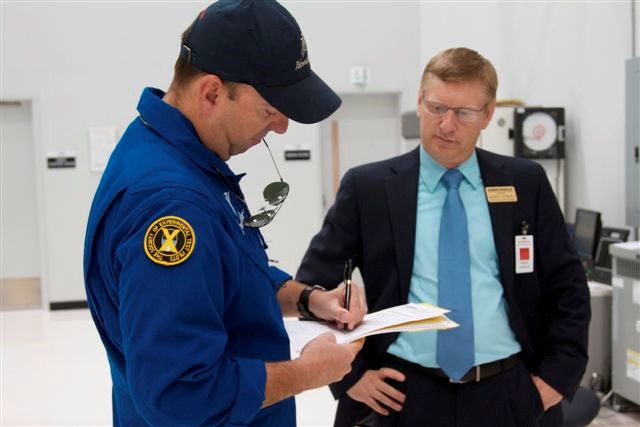 Pilot and businessperson signing paperwork