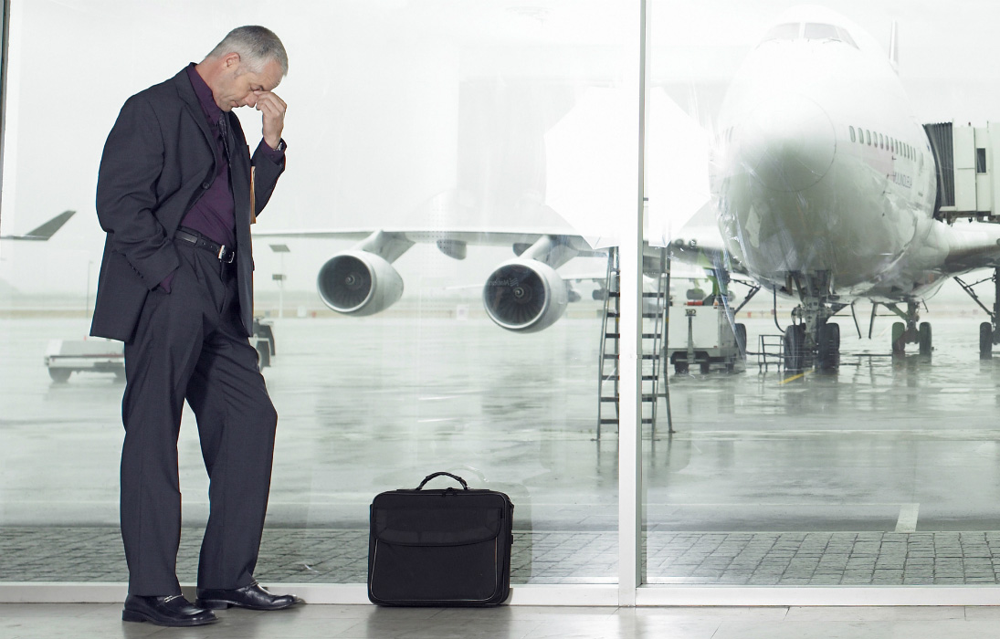 Business man waiting anxiously in airport terminal