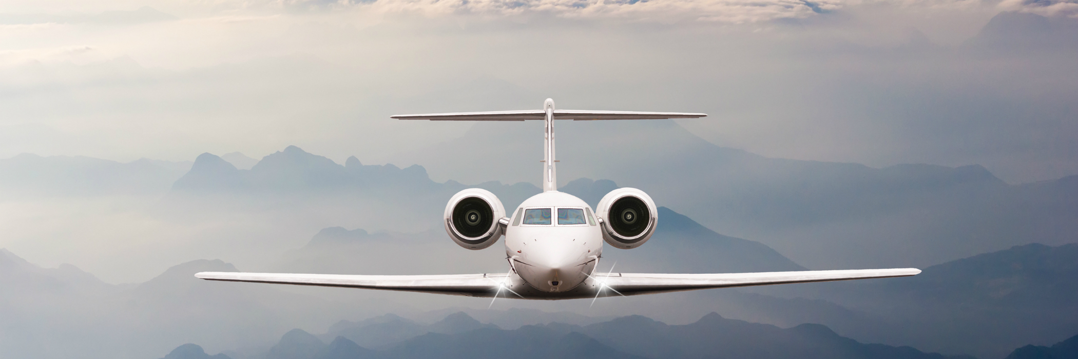 Gulfstream V in flight over foggy mountains