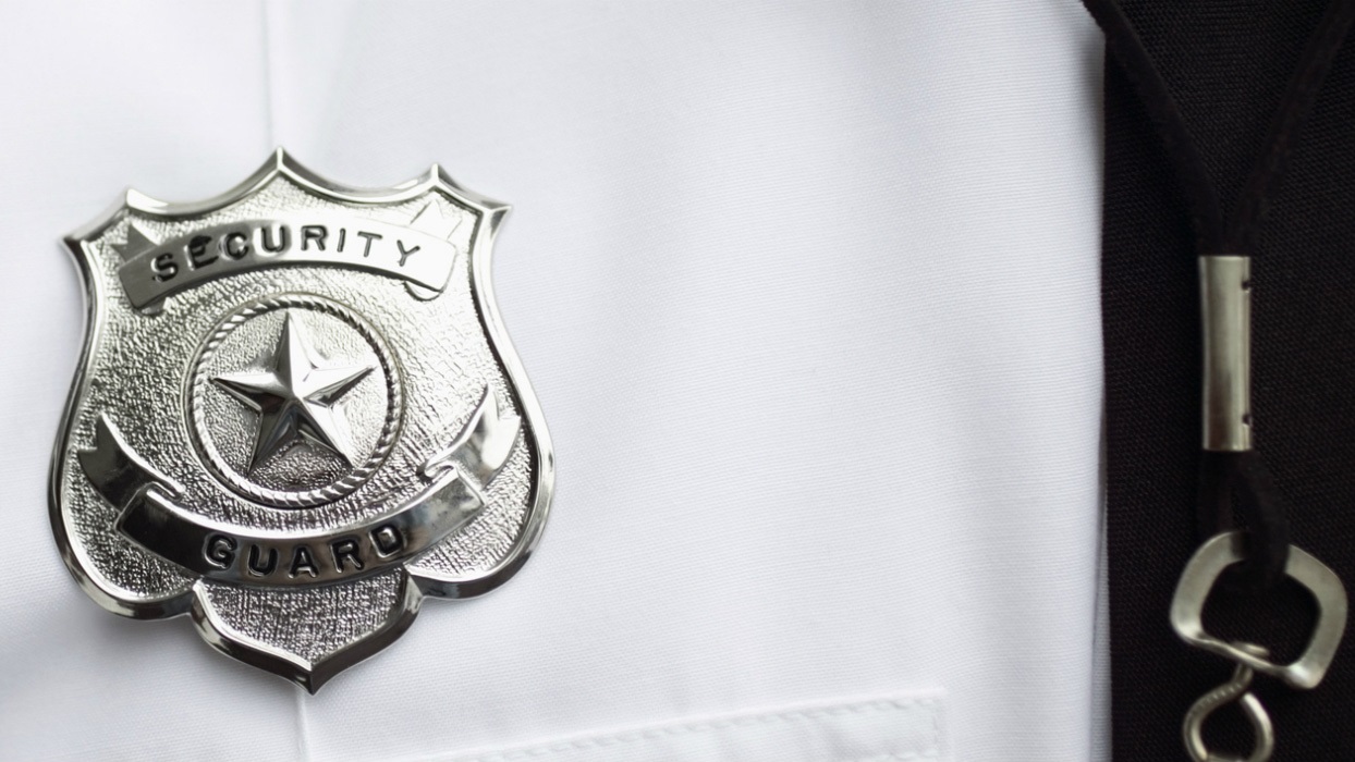 Close-up of security guard badge