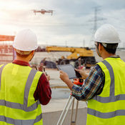 Woman operating sUAS over trees