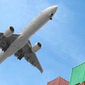 Plane flying over cargo containers