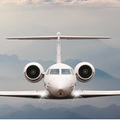 Gulfstream V in flight over foggy mountains