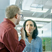 Two people reviewing graphics in a modern meeting room