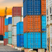 Shipping containers stacked in shipyard