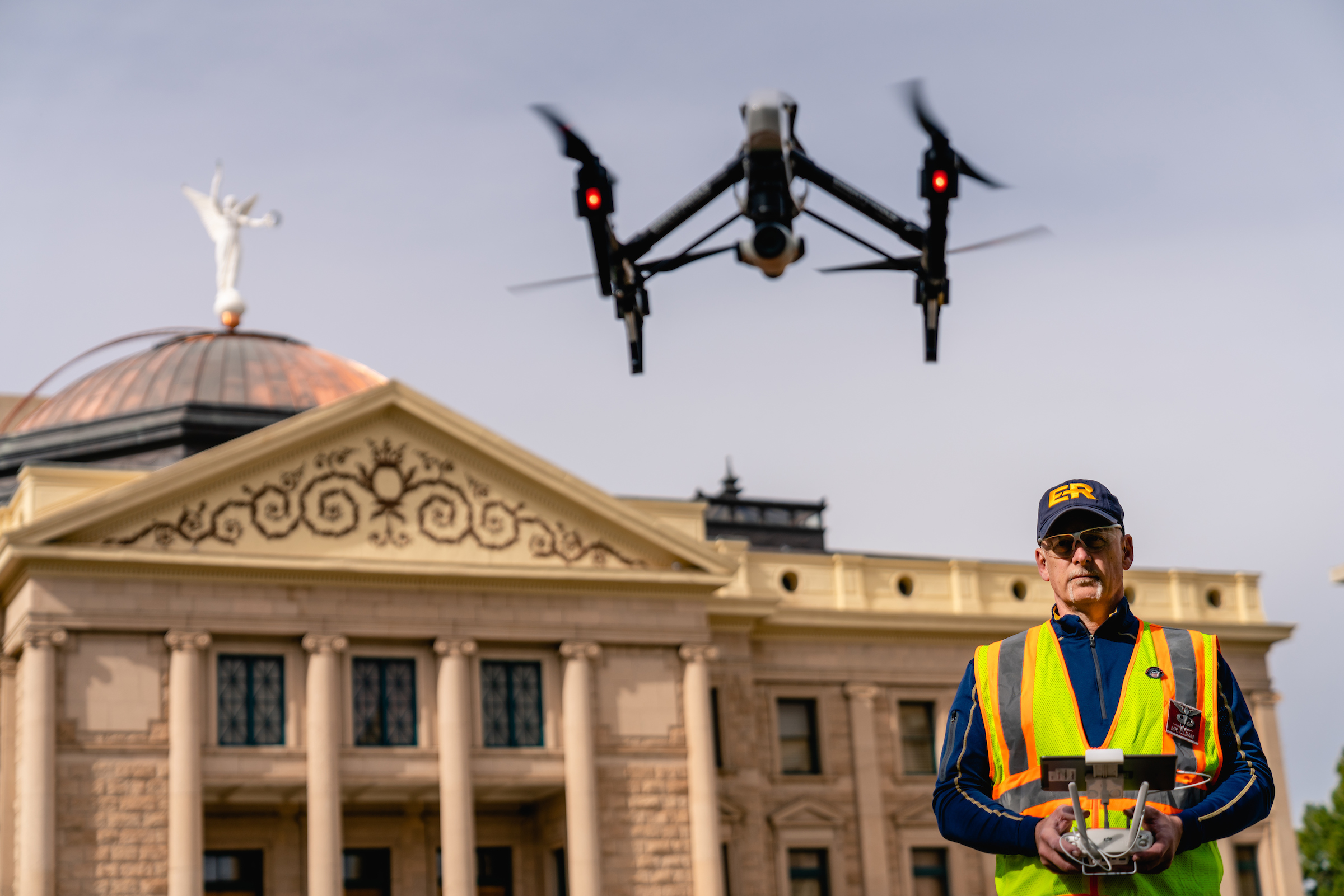 Operator flying sUAS in front of historic-looking building