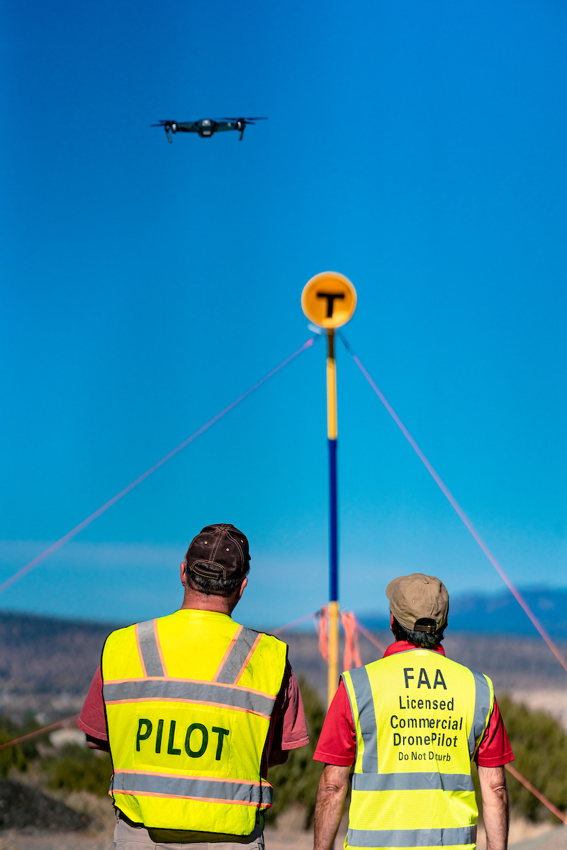 Two operators flying a sUAS over desert