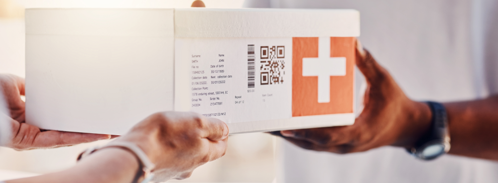 Medical professionals passing a box of medical supplies