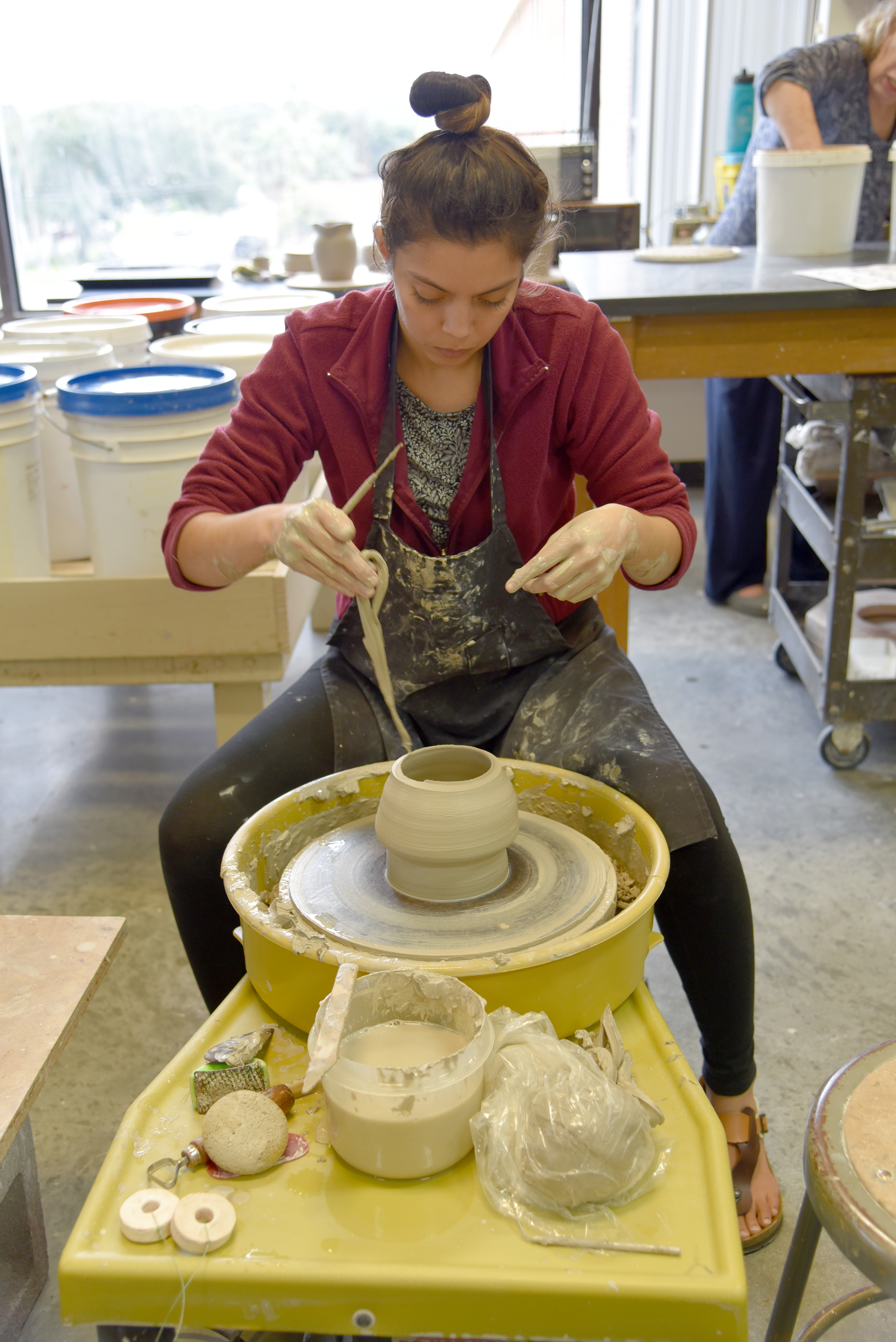 Student and pottery wheel;