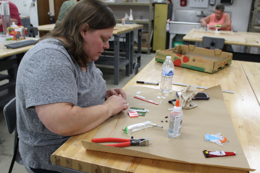 woman works on fused glass project